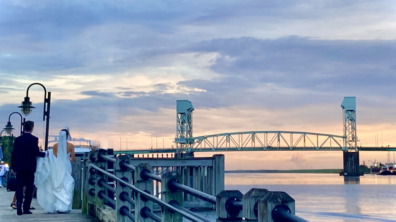 Newlyweds on the Wilmington Riverwalk at sunset